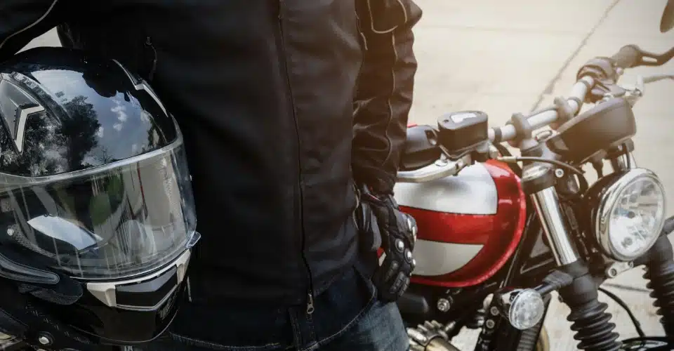 Close-up of a helmet, a motorcycle driver, and a motorcycle