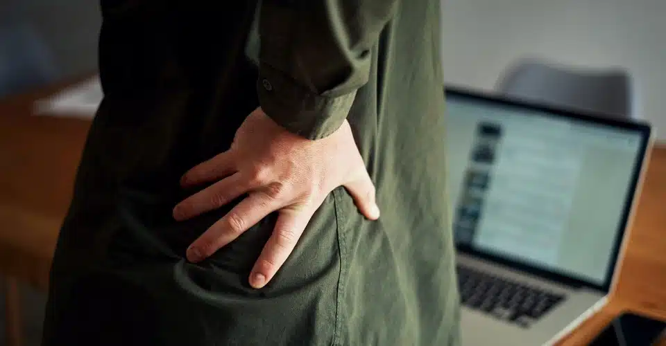 Close-up of a hand holding a back indicating strain and pain