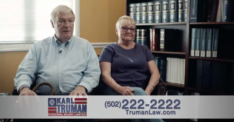 Two white couple sitting in a lawyer's office talking to the camera to tell their story