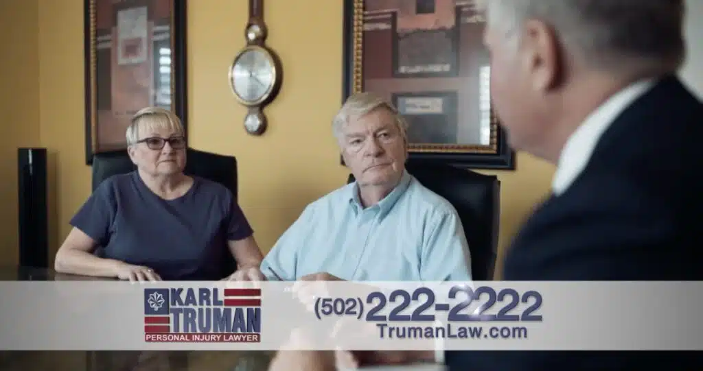 Two white couple looking on while the lawyer is consulting them for legal advice.