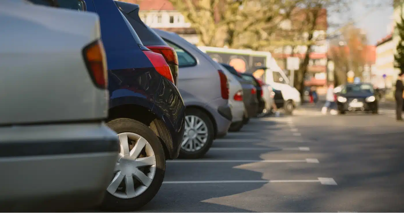 A row of cars in a parking lot