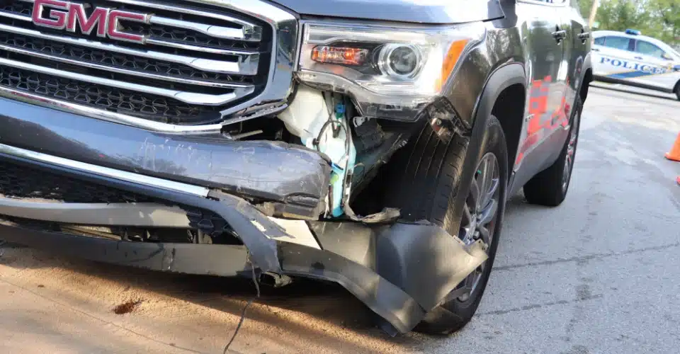 A close-up view of corner damage on a GMC vehicle