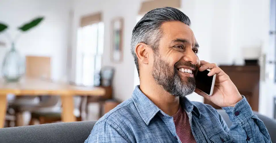 A man talking on the phone and smiling