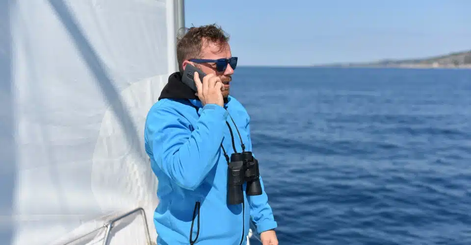 A man making a phone call while on a boat