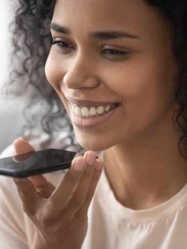 Veteran using smartphone for voice recognition, illustrating hearing loss claim process.