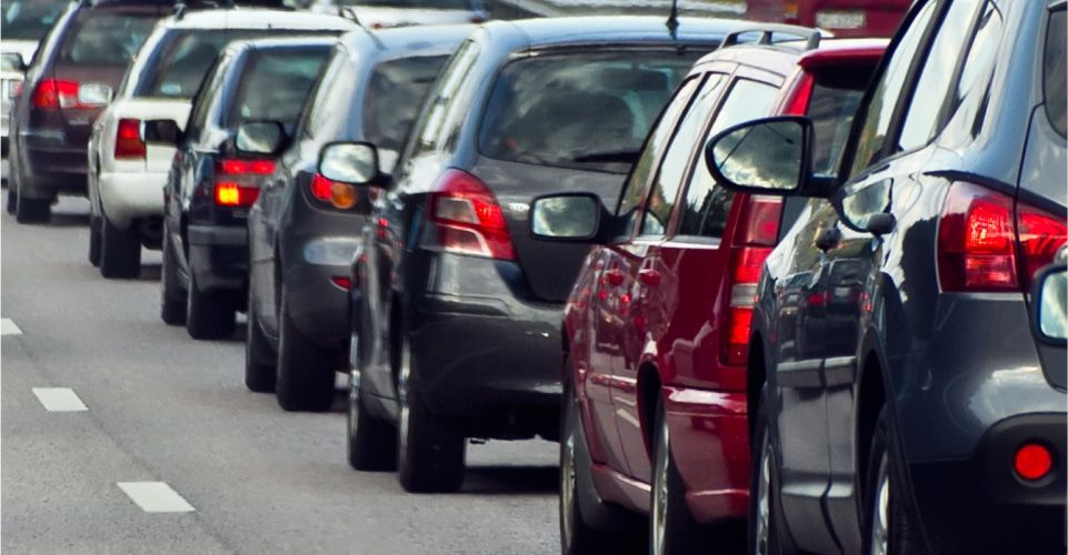 Traffic congestion and inconsistent speed illustrating distracted driving signs.
