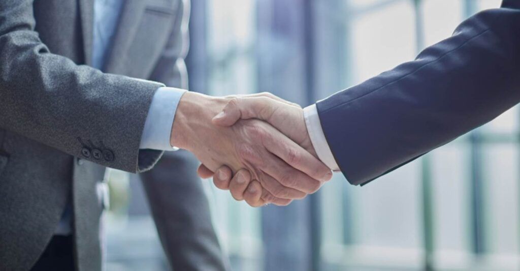 close-up of a person shaking hands with an attorney